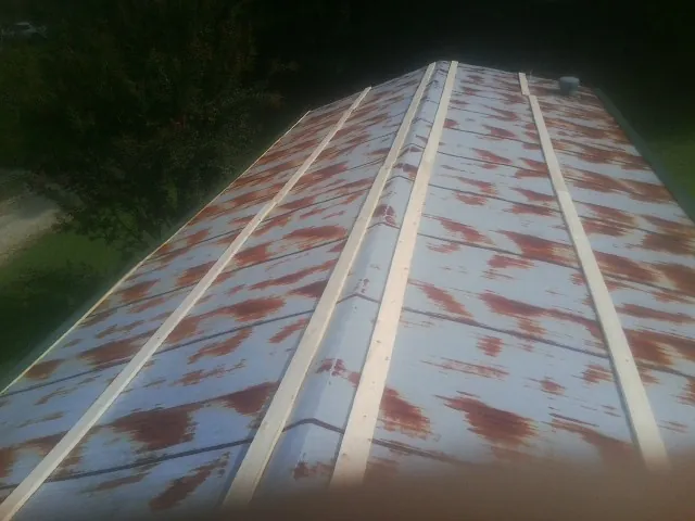 Rusted metal roof panels with new wood purlins before replacement — Storm Damage Roof Repair in Gum Spring by Roofing Brothers