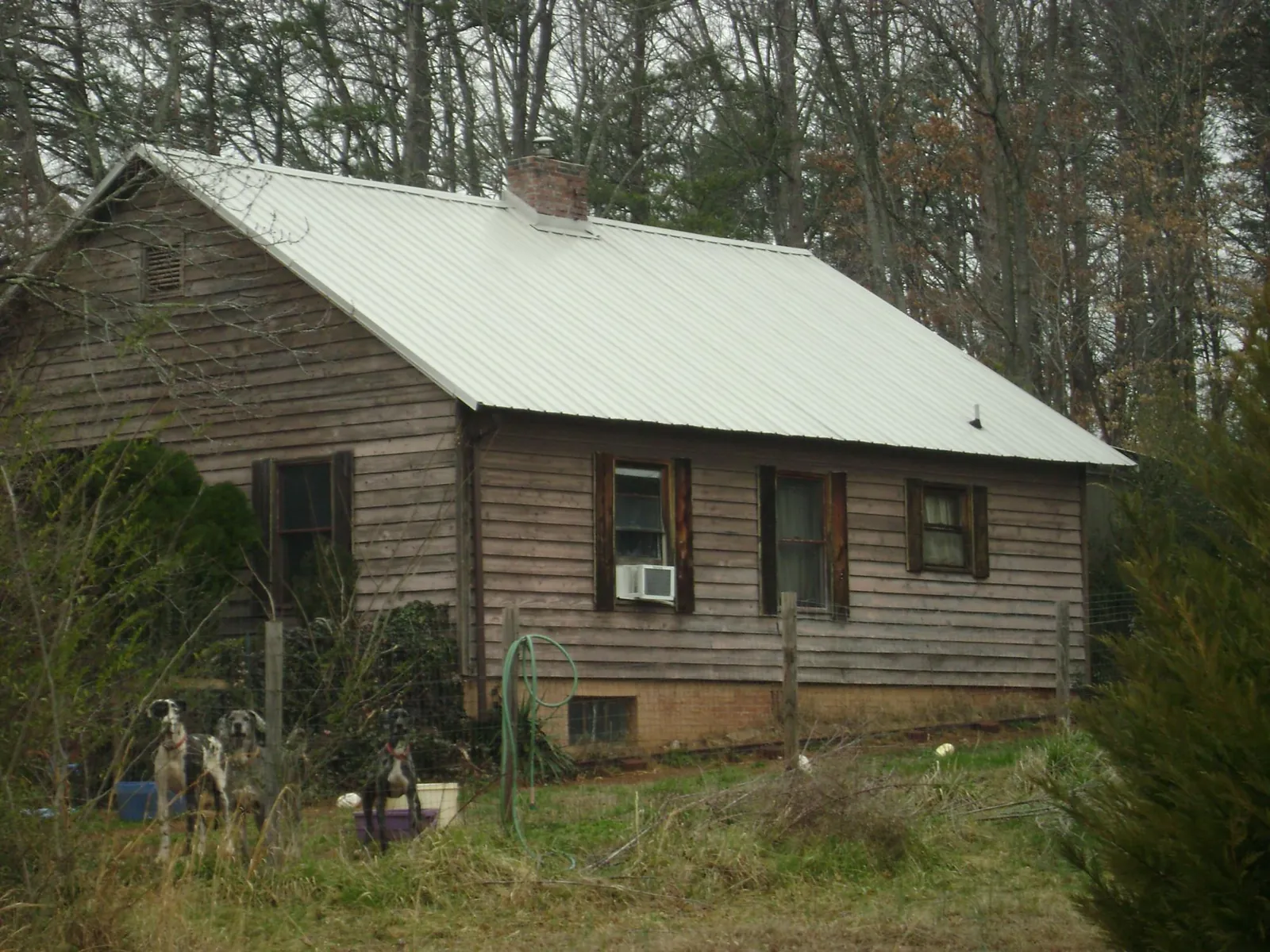 White metal roof on an old wood sided farmhouse, from a Metal Roof Installation job in Gum Spring